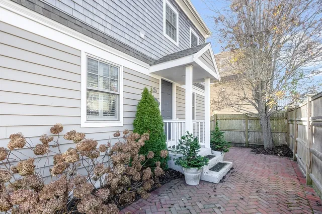 a view of a house with a yard and tree