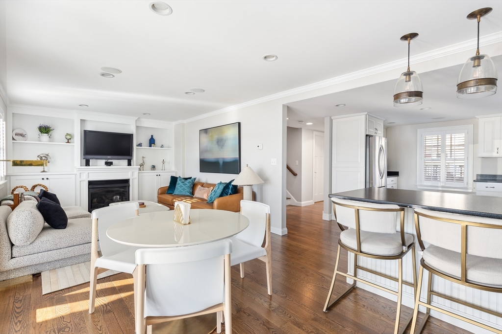 25 Bay Street Hull, MA 02045 - Photo 4 of 27 a kitchen with a dining table chairs workspace and a sink