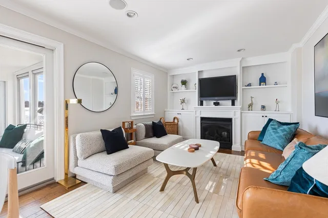 a living room with furniture a fireplace a flat screen tv and a fireplace