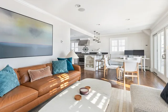 a living room with furniture and view of kitchen