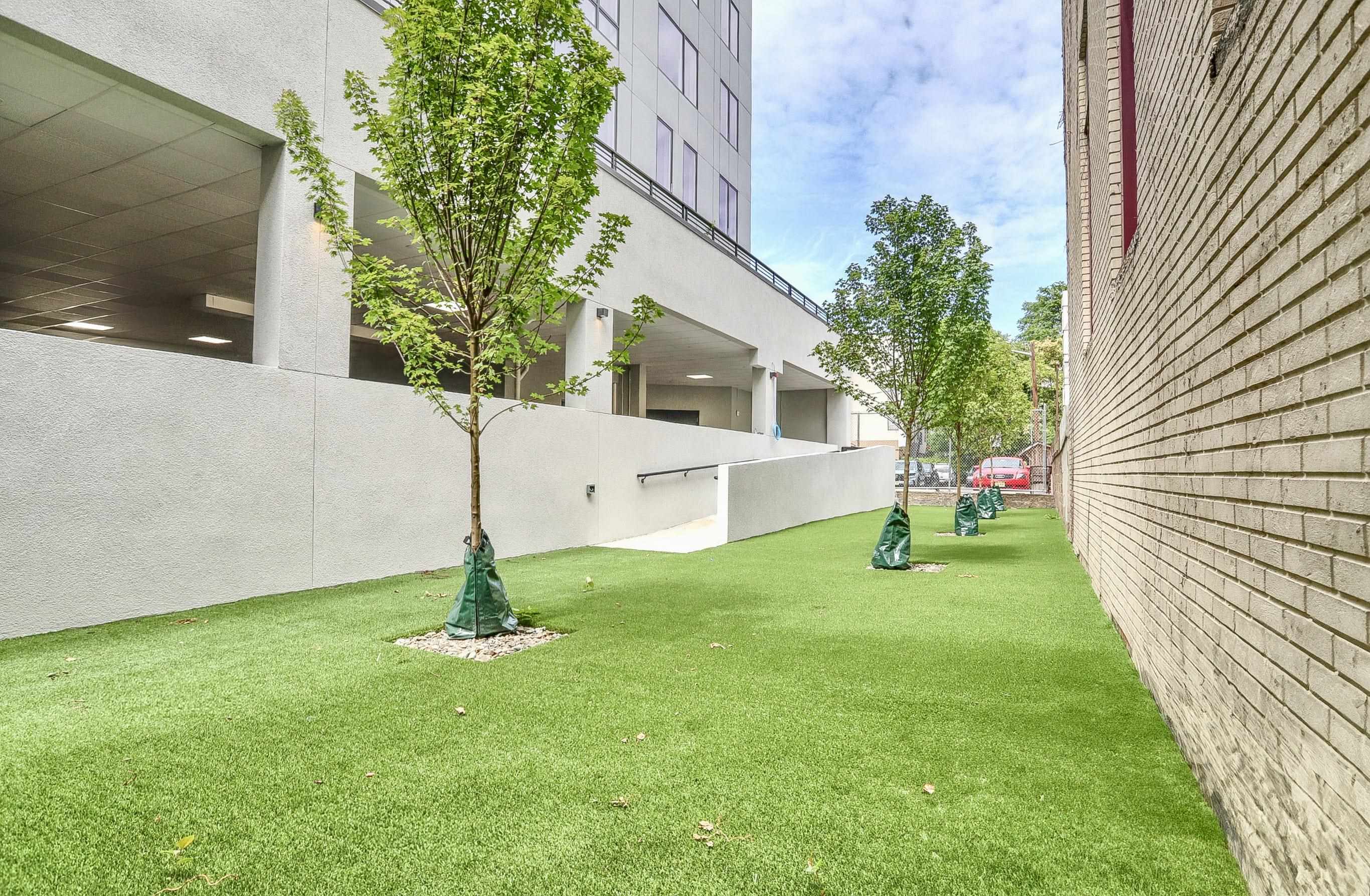 303 Madison Street, Unit 408 Hoboken, NJ 07030 - Photo 15 of 26 a house with garden in front of it