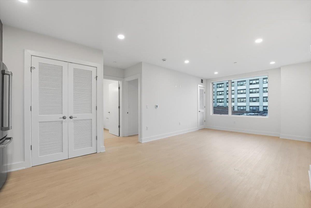 303 Madison Street, Unit 408 Hoboken, NJ 07030 - Photo 9 of 26 an empty room with windows