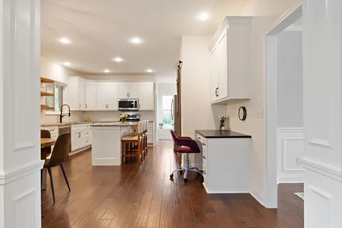a kitchen with stainless steel appliances granite countertop a sink and a stove