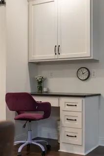a view of an empty room with wooden floor and a hallway