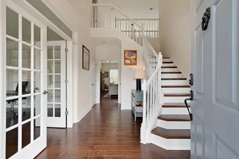 a view of entryway and hall with wooden floor