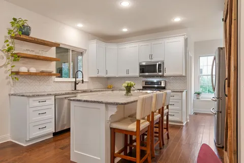 a white bath tub sitting in a bathroom next to a window