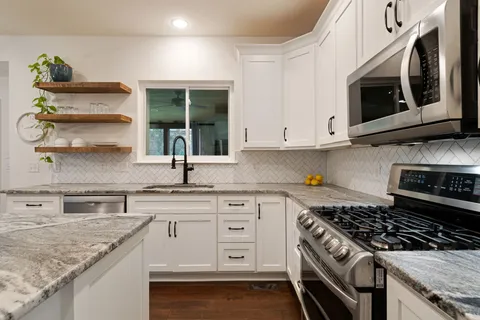 a bedroom with a large bed and a chandelier