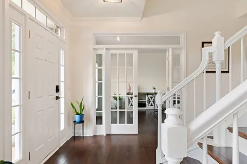 a view of a a dining room with furniture window and wooden floor