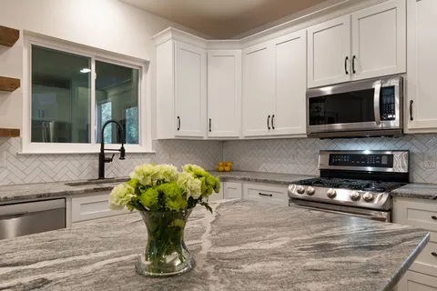 a living room with furniture a flat screen tv and a floor to ceiling window