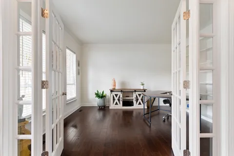 a workspace with furniture window and wooden floor