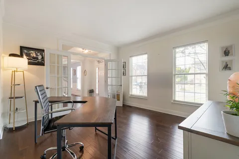 a view of a dining room with furniture wooden floor and chandelier