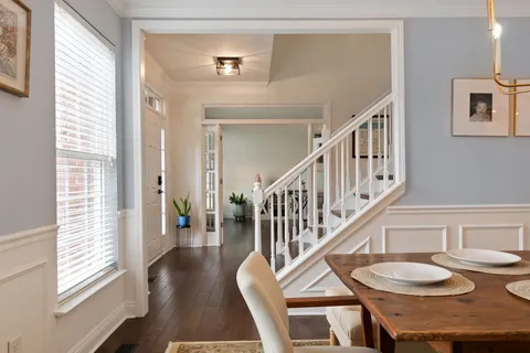a living room with a bed furniture and a window