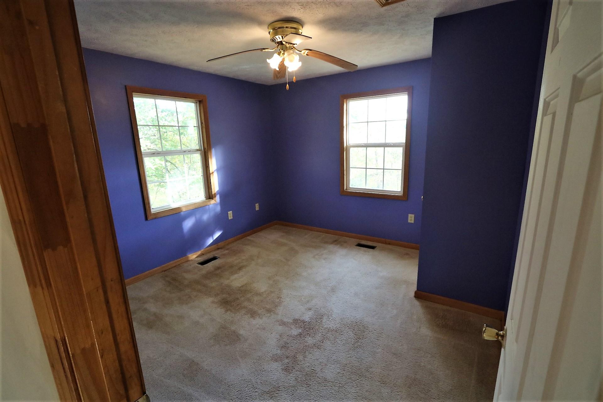 174 Spring Dale Road Southwest Floyd, VA 24091 - Photo 22 of 37 a view of an empty room with window and chandelier fan