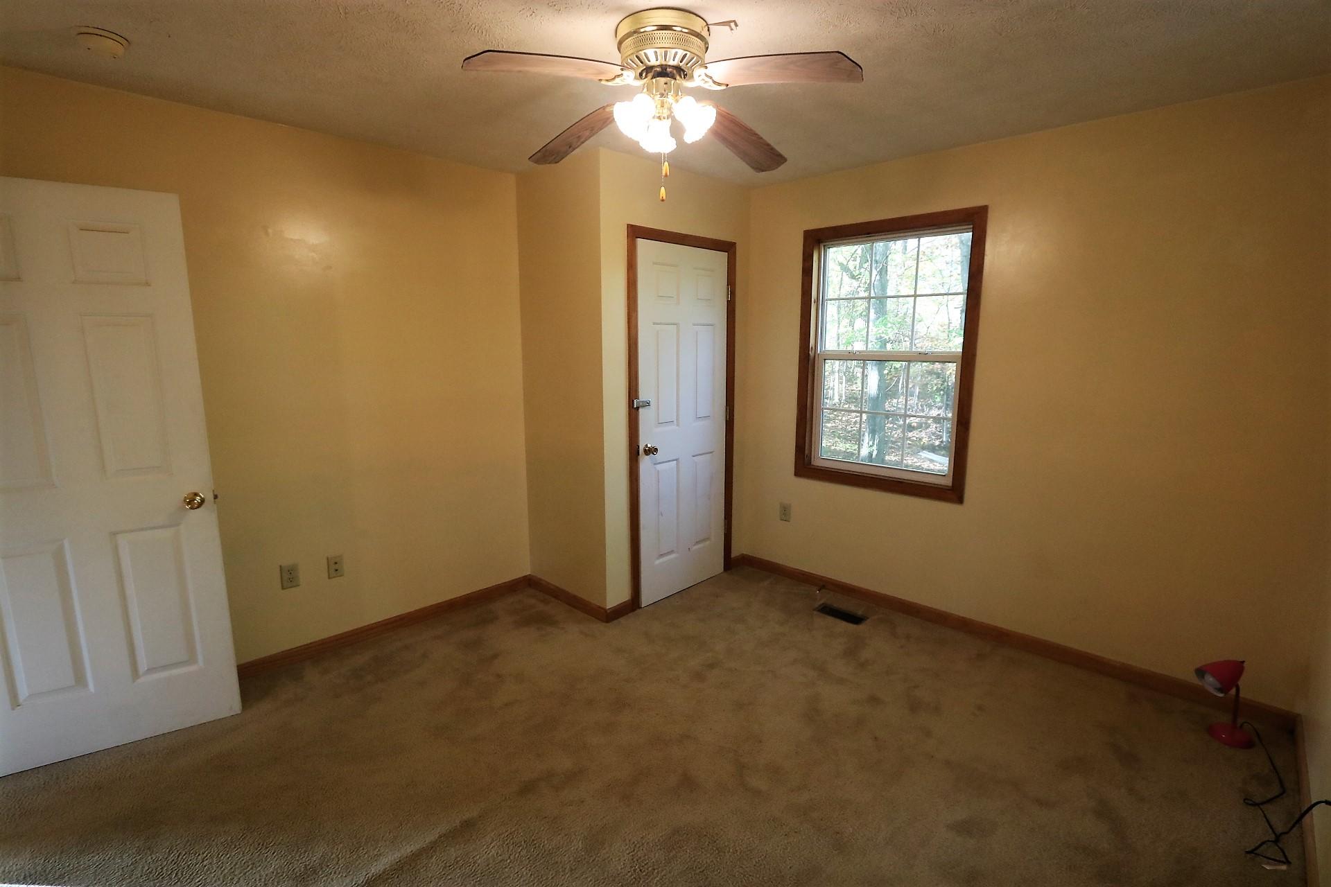 174 Spring Dale Road Southwest Floyd, VA 24091 - Photo 27 of 37 an empty room with windows and fan