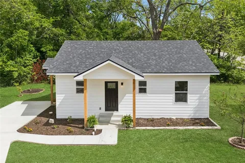 a aerial view of a house with a yard