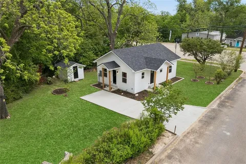 a aerial view of a house with a yard