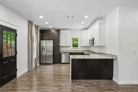 a kitchen with stainless steel appliances granite countertop a stove and a refrigerator