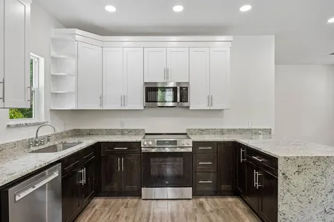 a kitchen with a sink and a stove top oven