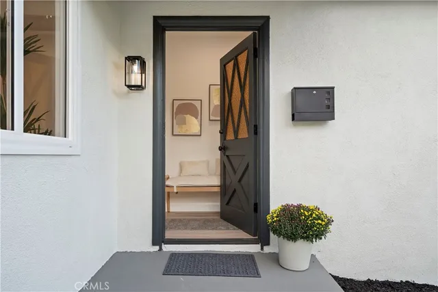 a view of a hallway with wooden floor and a potted plant