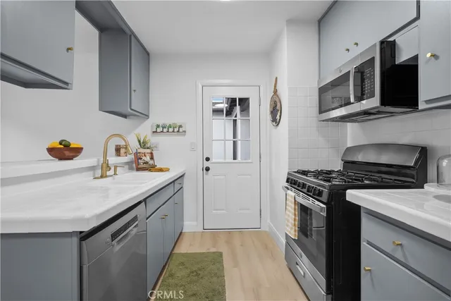 a kitchen with stainless steel appliances granite countertop a stove and a sink