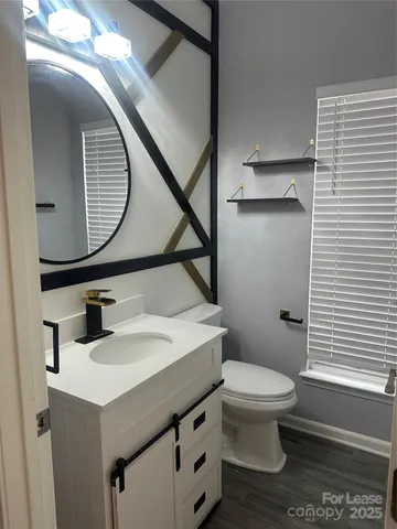 a bathroom with a sink a toilet and mirror