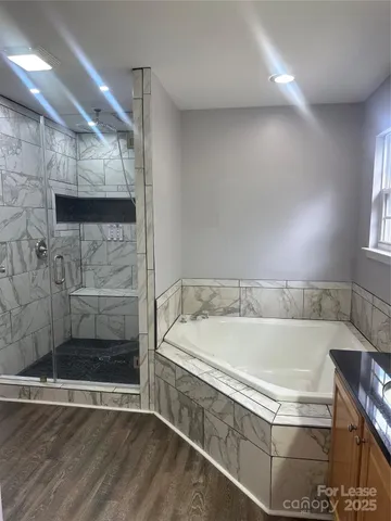 a bathroom with a bathtub and a shower