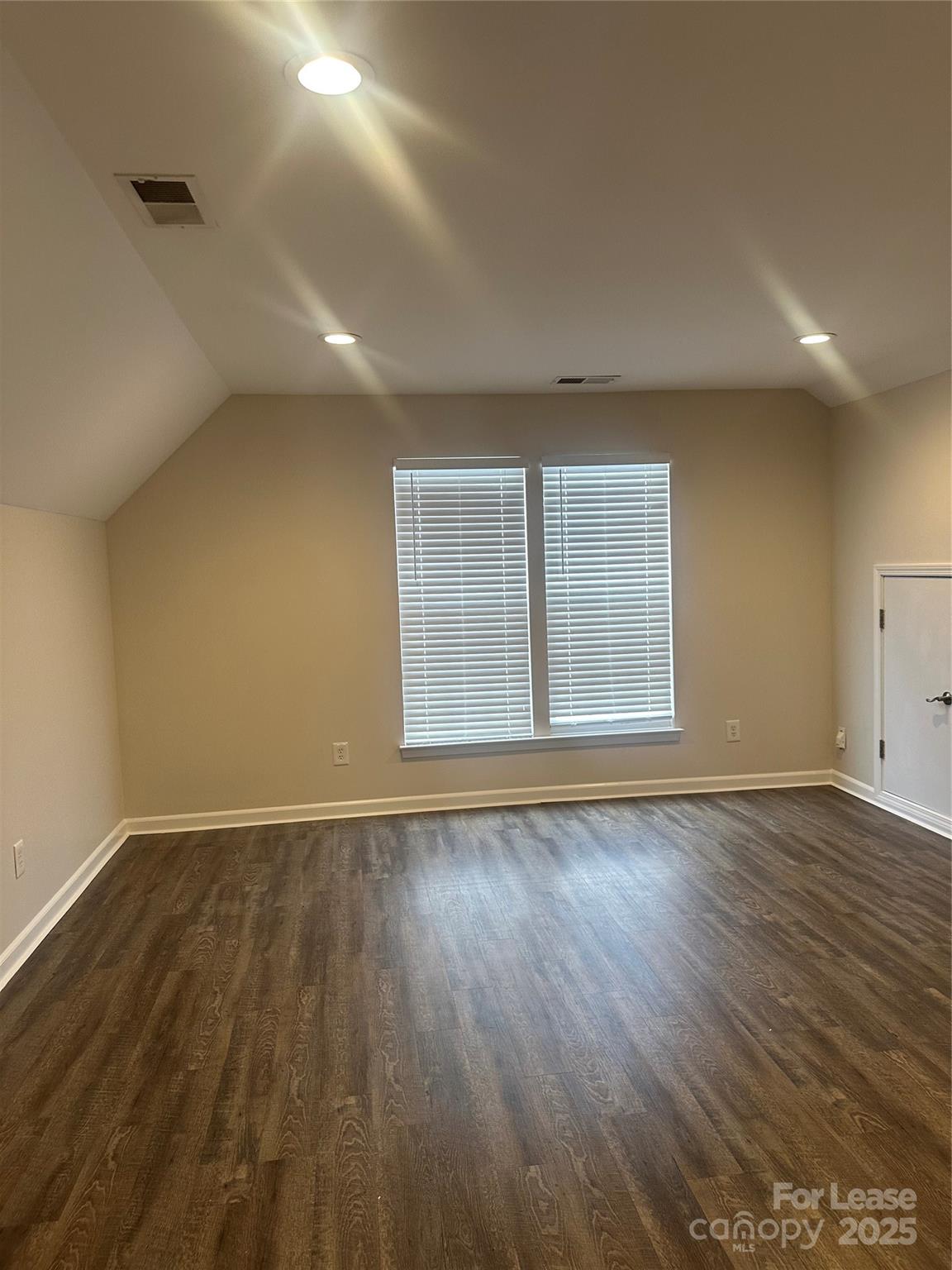 618 Circle Trace Road Monroe, NC 28110 - Photo 19 of 21 a view of an empty room with wooden floor and a window