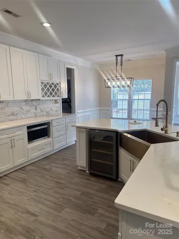 a kitchen with stainless steel appliances granite countertop a sink and dishwasher a stove with wooden floors