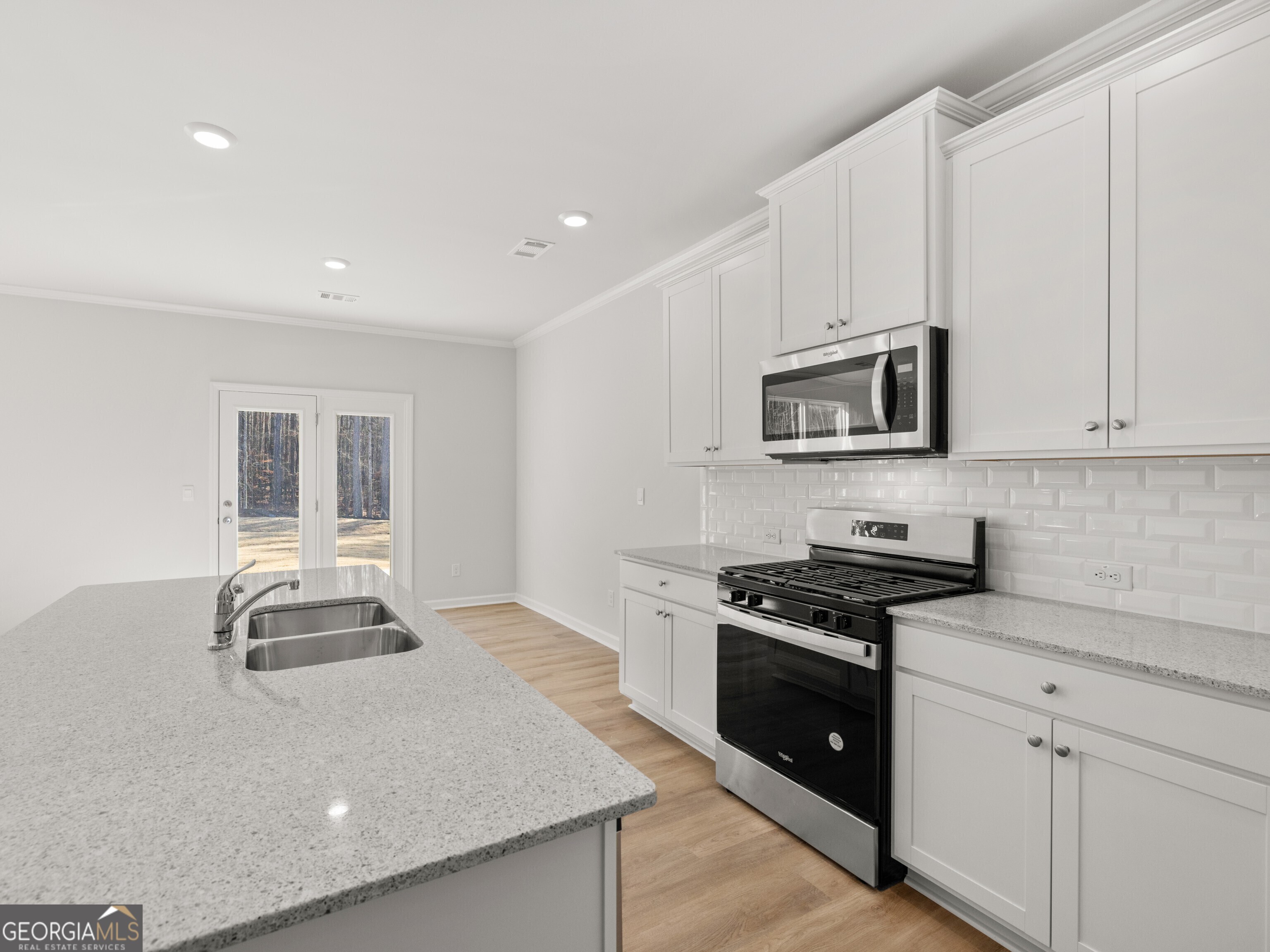 156 Hampton Drive Dallas, GA 30132 - Photo 10 of 81 a kitchen with granite countertop white cabinets and stainless steel appliances