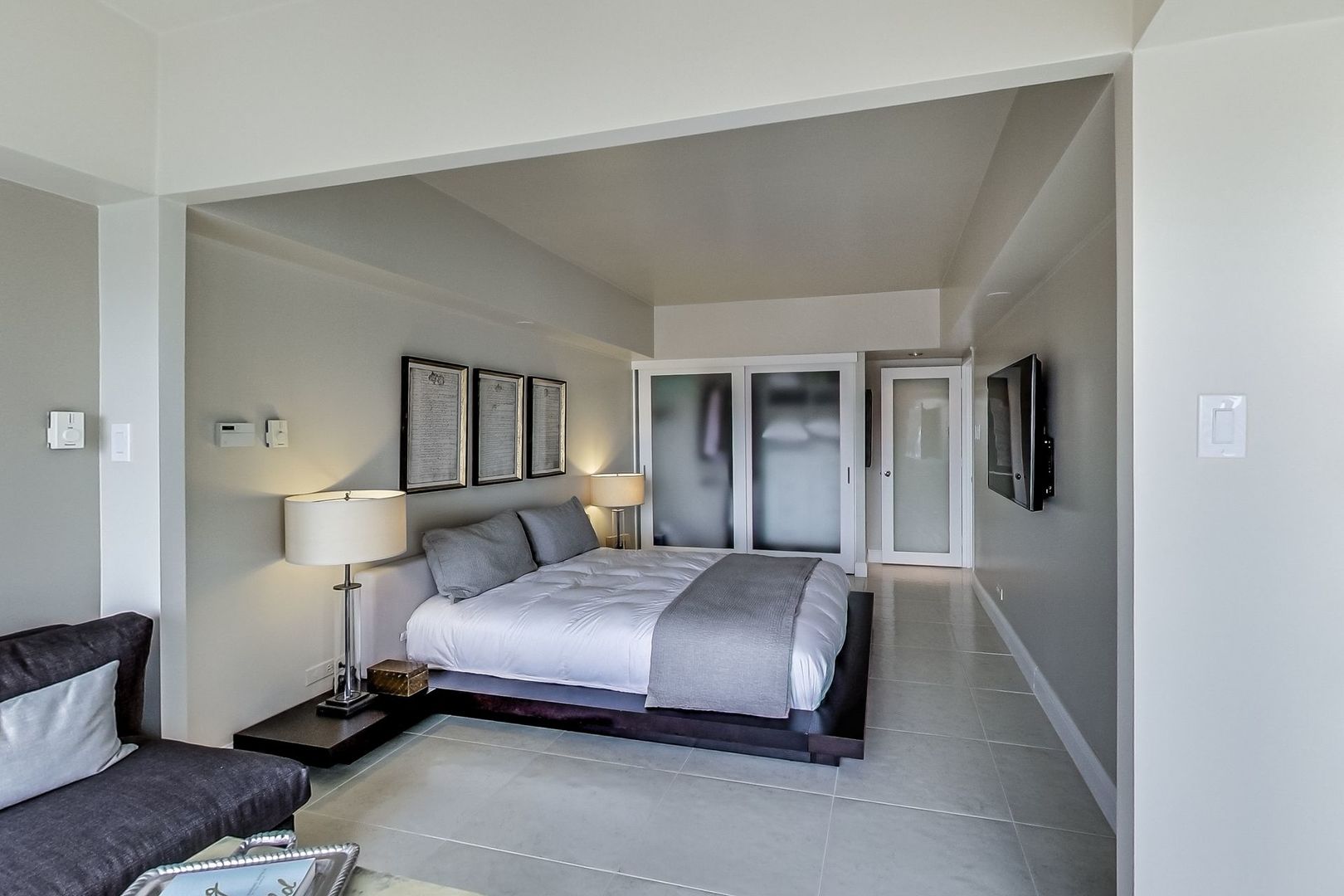 175 East Delaware Place, Unit 5819 Chicago, IL 60611 - Photo 11 of 22 a bedroom with a bed and lamp