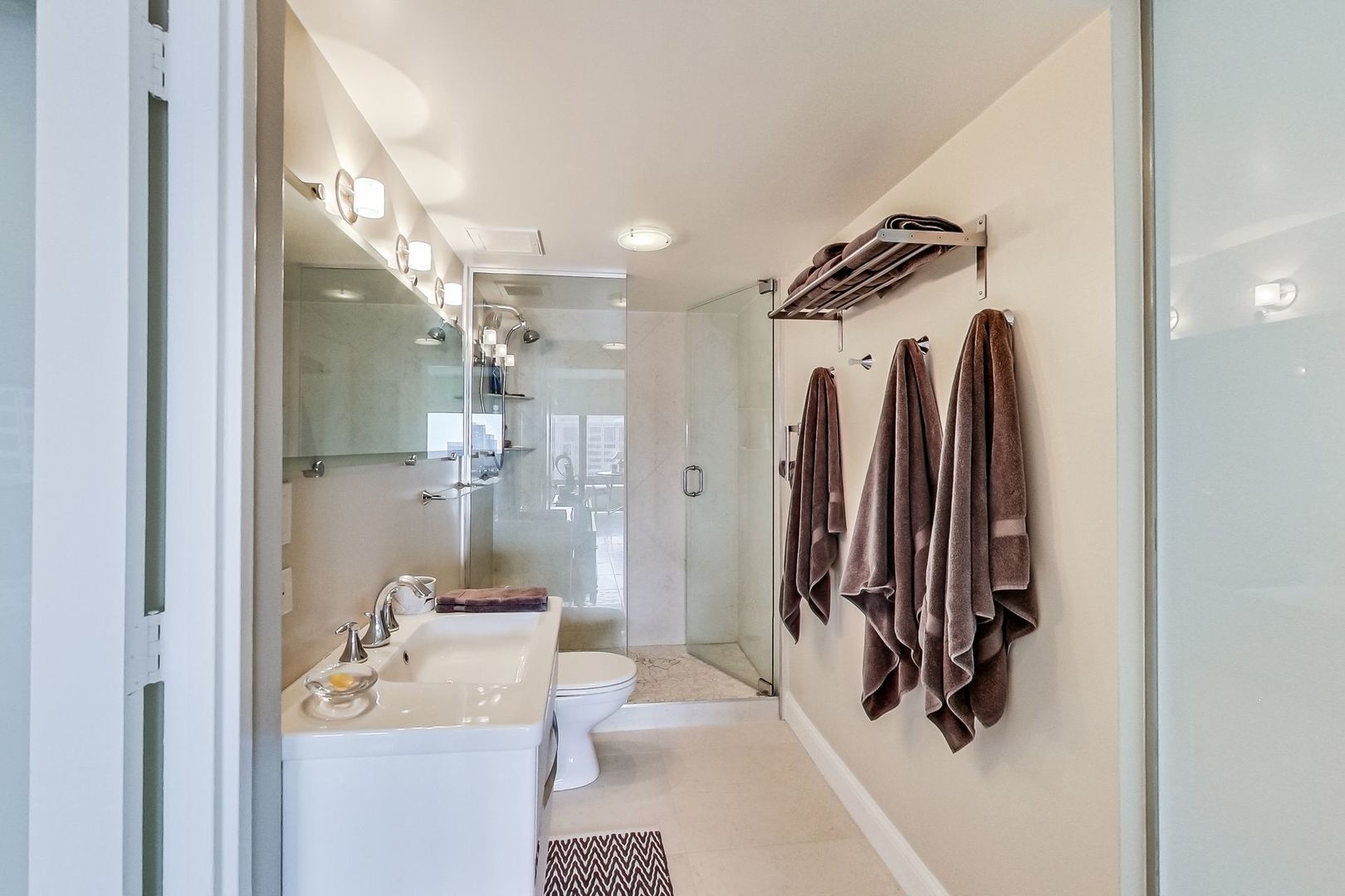 175 East Delaware Place, Unit 5819 Chicago, IL 60611 - Photo 15 of 22 a bathroom with a sink toilet and shower