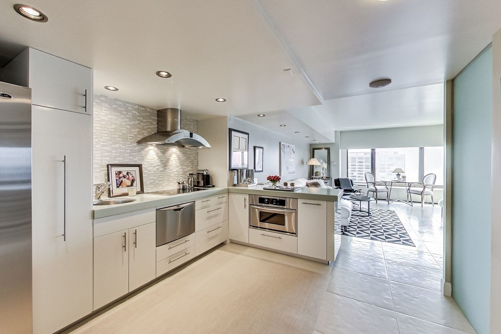 175 East Delaware Place, Unit 5819 Chicago, IL 60611 - Photo 4 of 22 a kitchen with white cabinets and appliances