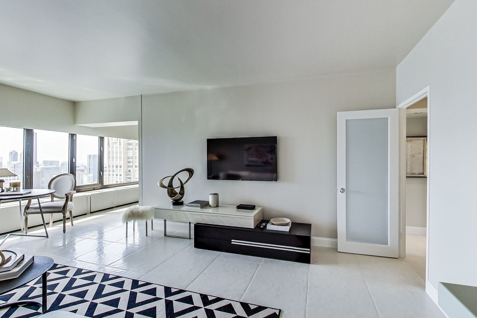 175 East Delaware Place, Unit 5819 Chicago, IL 60611 - Photo 8 of 22 a living room with furniture and a flat screen tv