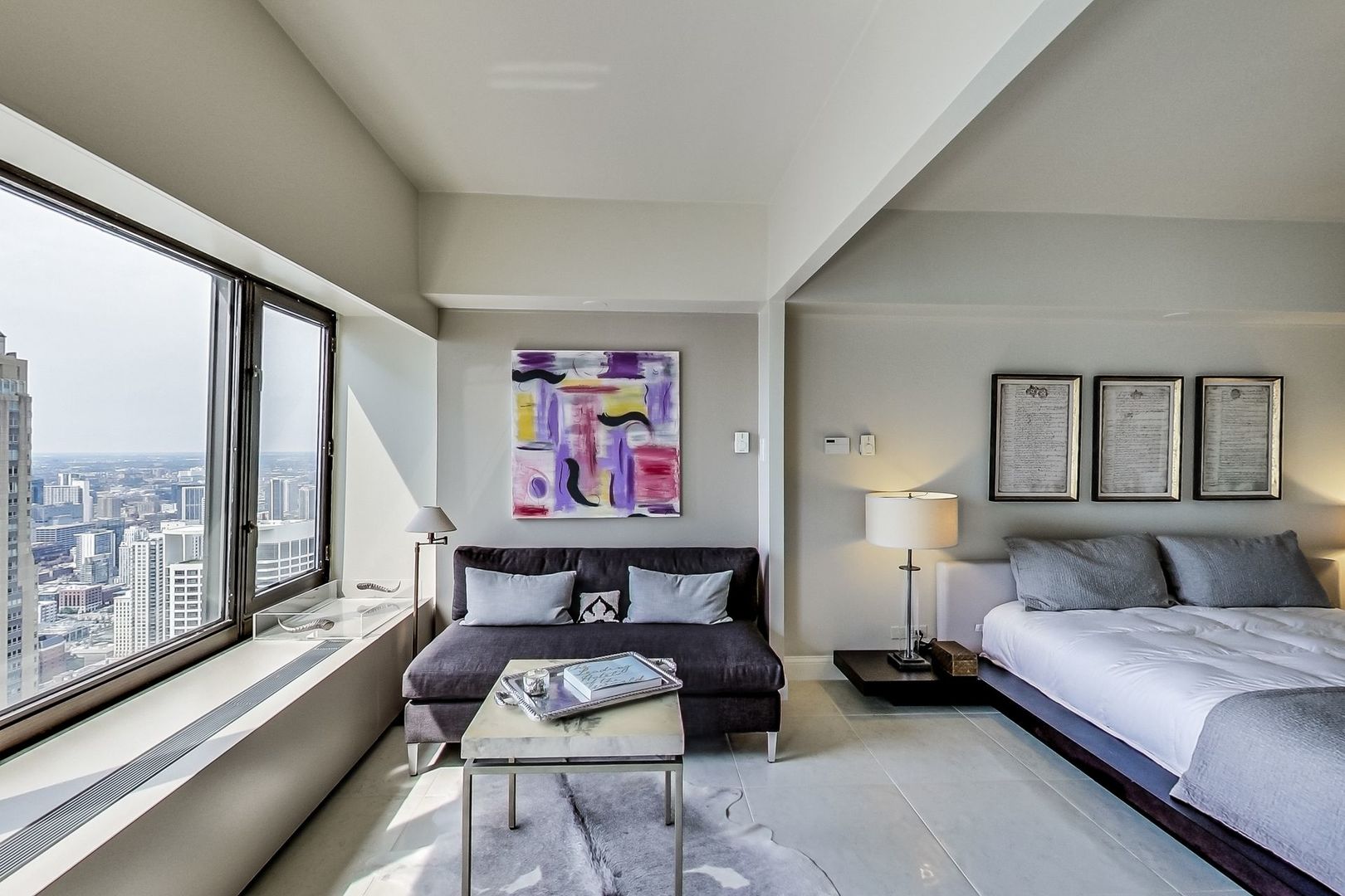 175 East Delaware Place, Unit 5819 Chicago, IL 60611 - Photo 10 of 22 a living room with furniture and a large window