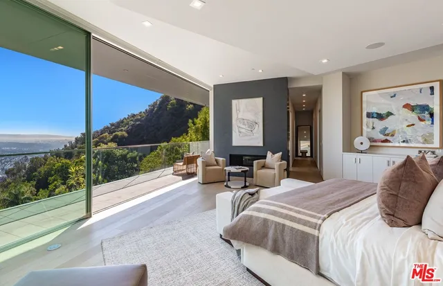 a bedroom with a large bed and a painting on the wall