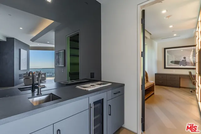 a kitchen with sink refrigerator and window