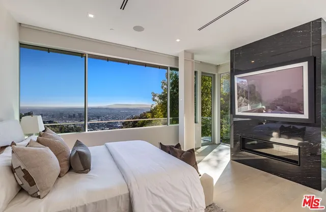 a bedroom with a large bed and a balcony view