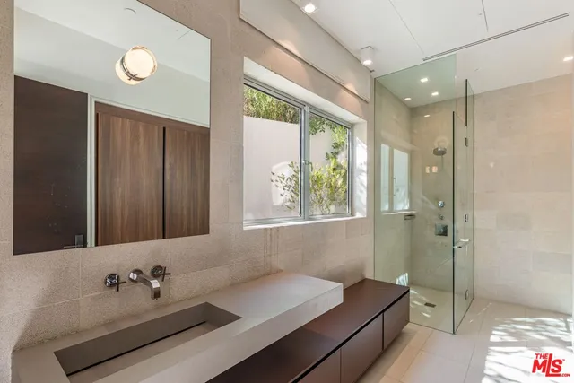 a bathroom with a tub sink and mirror