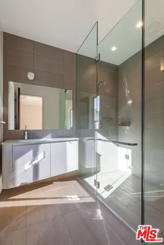 a bathroom with a granite countertop sink mirror and bathtub