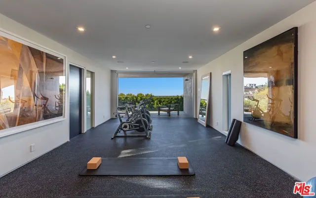 a bathroom with a granite countertop sink a mirror and shower