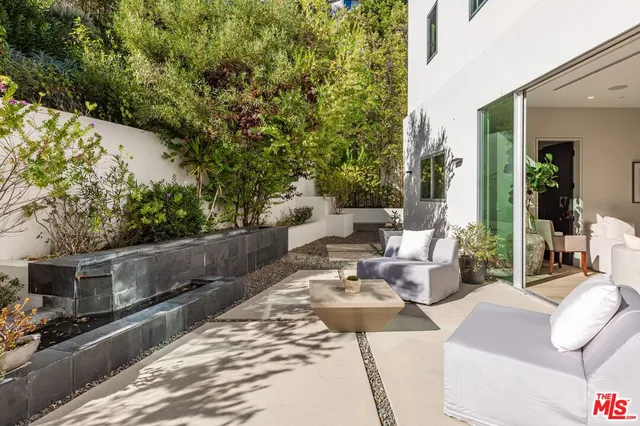 a view of backyard with seating area and green space