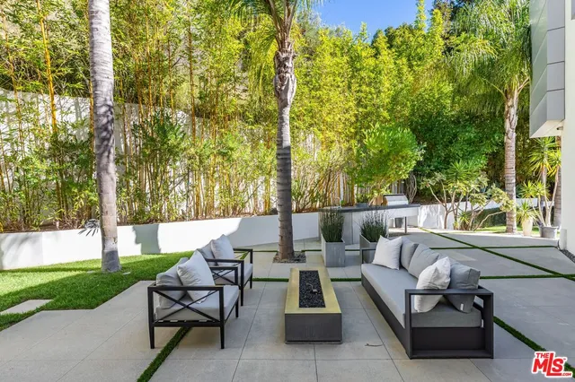 a terrace with outdoor seating and trees