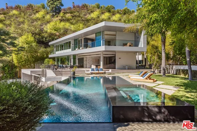 an aerial view of a house with swimming pool patio and outdoor seating