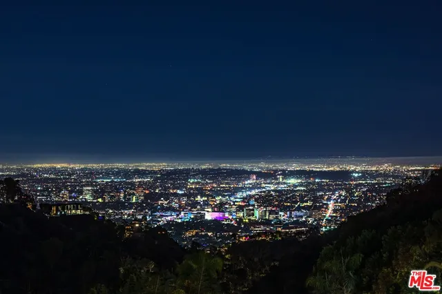a view of swimming pool outdoor seating and city view