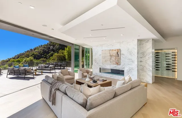 a living room with furniture and a floor to ceiling window