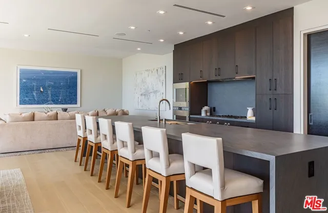 a large kitchen with a table chairs and a refrigerator