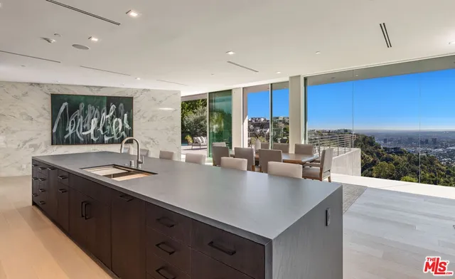 a kitchen with stainless steel appliances granite countertop a sink a stove and a refrigerator