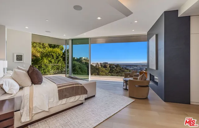 a spacious bedroom with a large bed and a couch