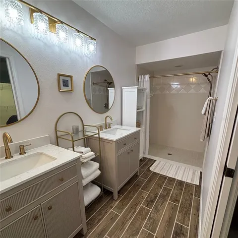 a bathroom with a double vanity sink mirror and toilet