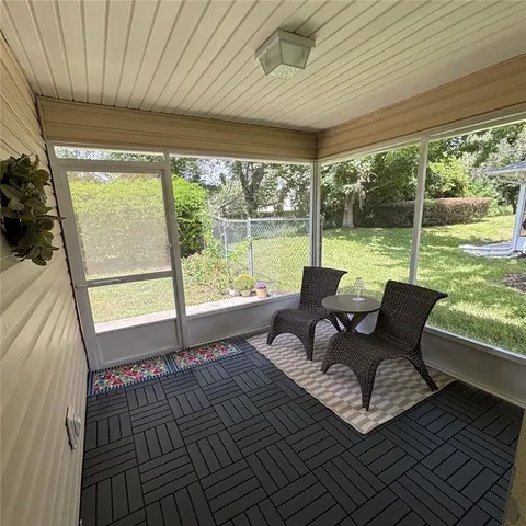 a balcony with wooden floor outdoor seating and nature